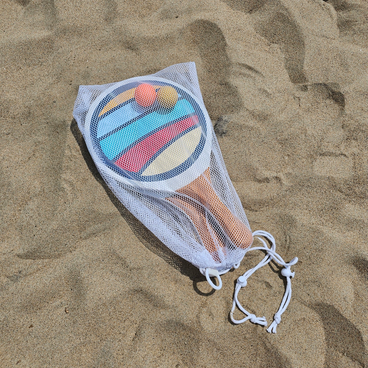 Suniela Beach paddleball game in mesh bag on the sand